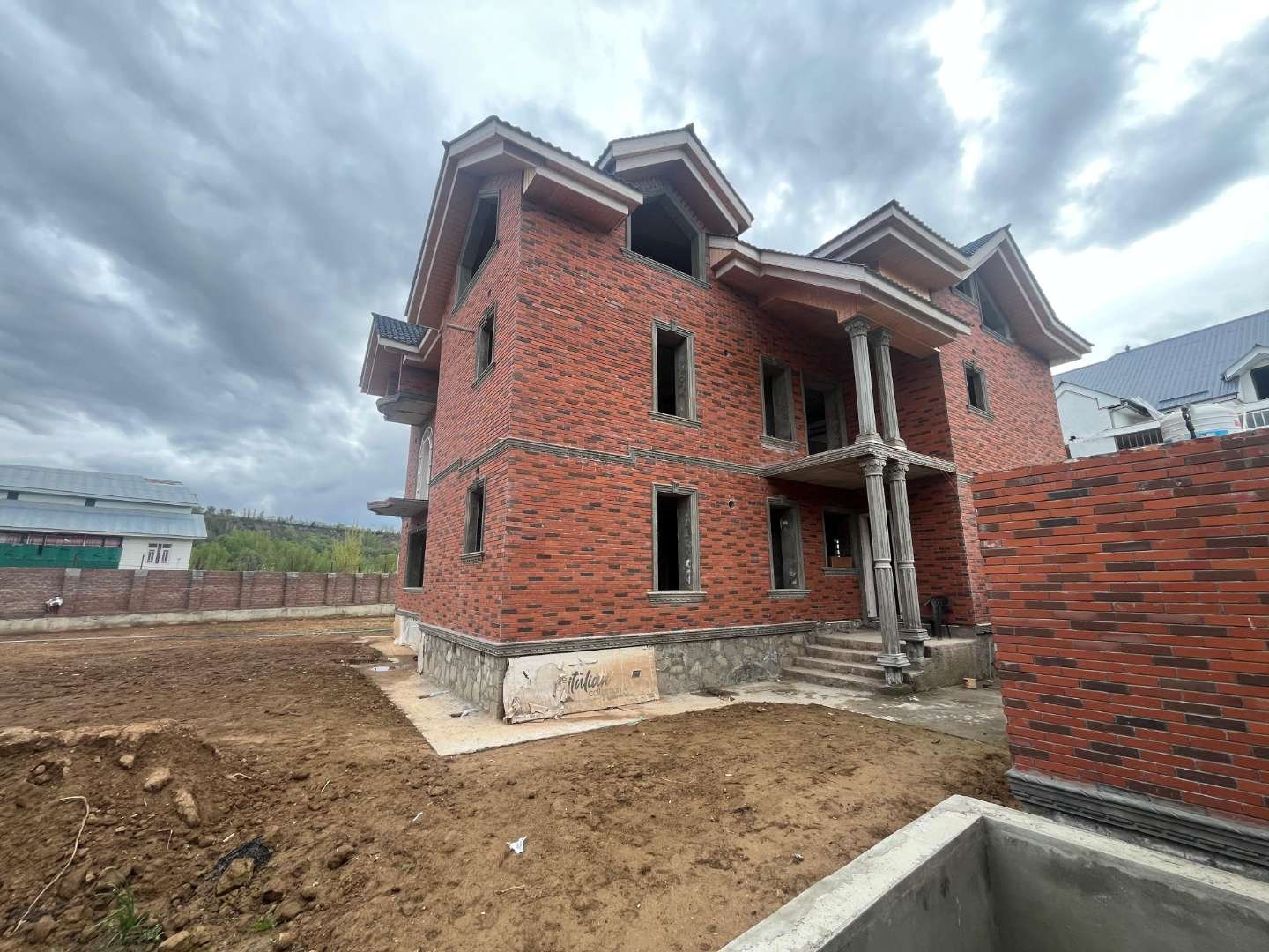 Residential building under construction with red brick cladding — Bricks Street