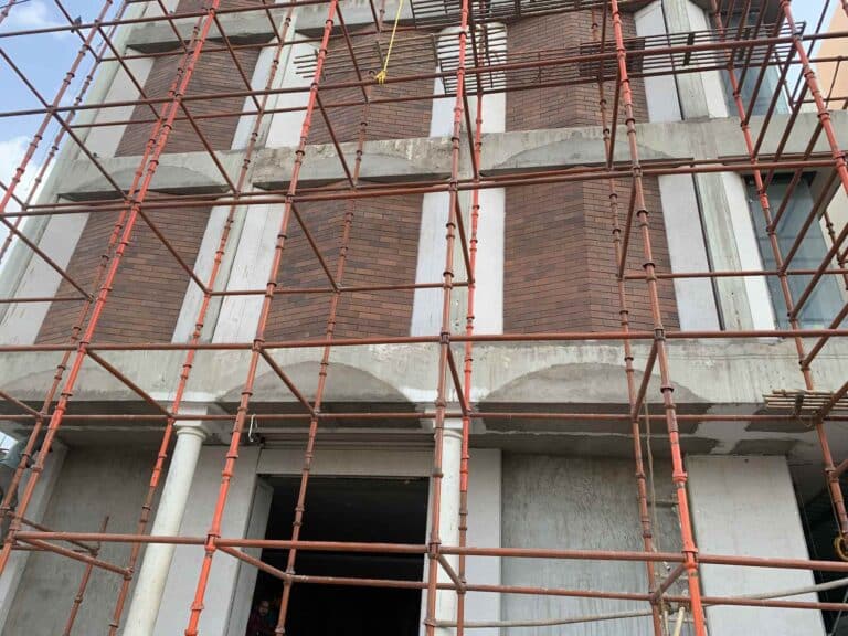 Multi-storey exposed brick building by Bricks Street