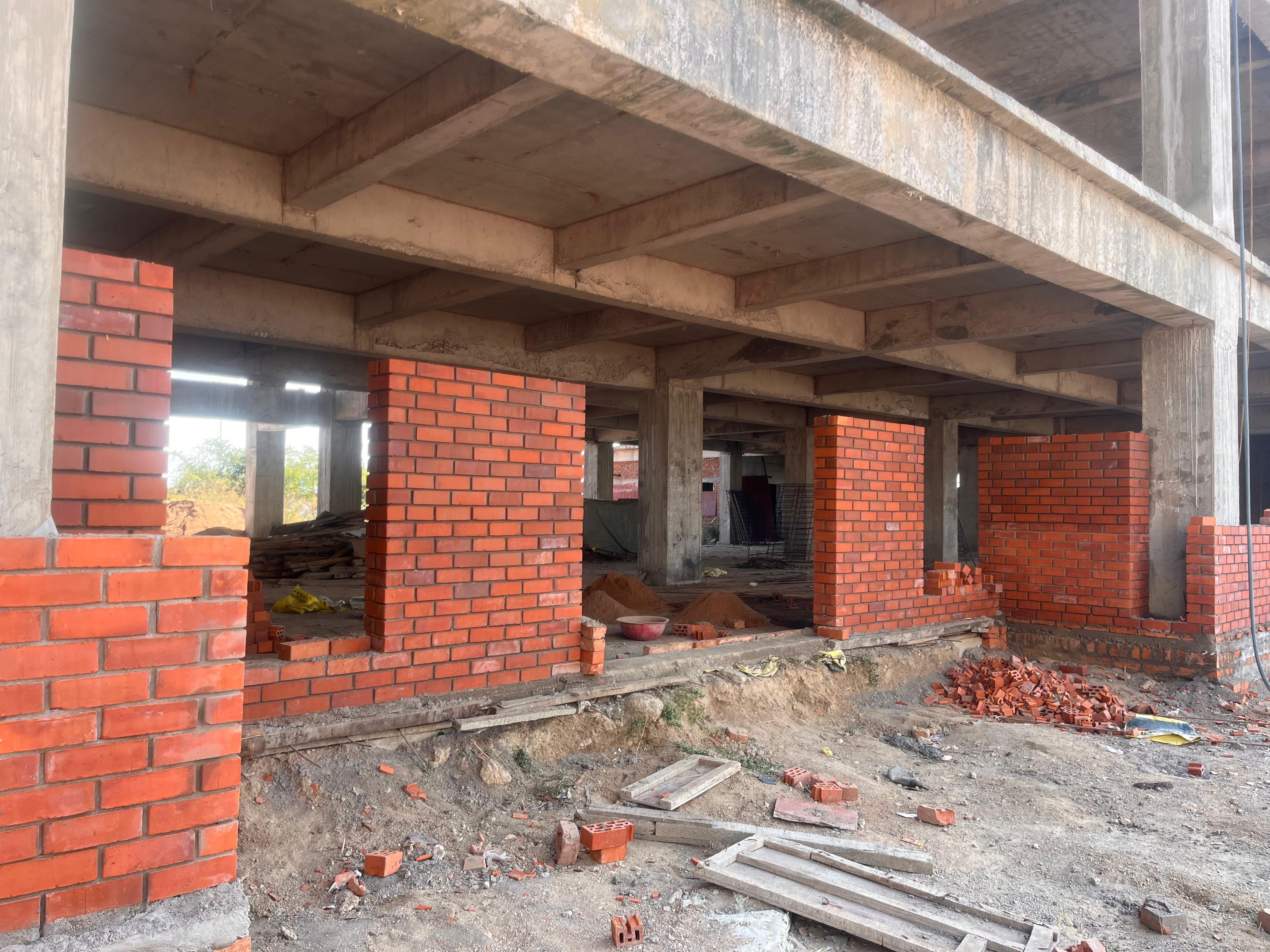 Wire cut brick columns and walls under construction — Bricks Street